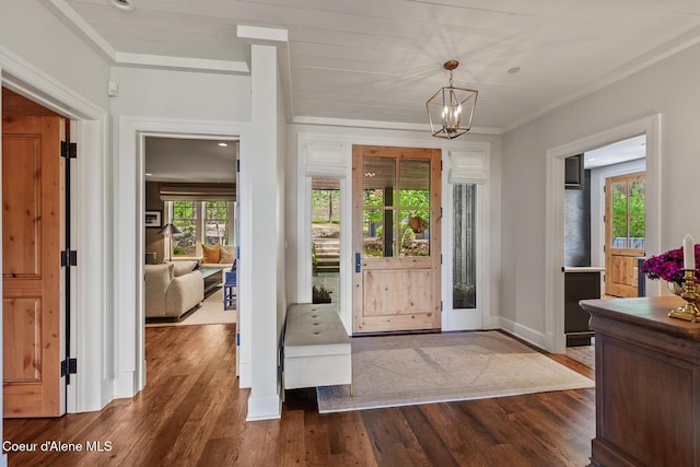 7783 S Buckrail Rd, Harrison, ID 83833 - foyer entrance featuring crown molding, a chandelier, dark wood-style flooring, and baseboards