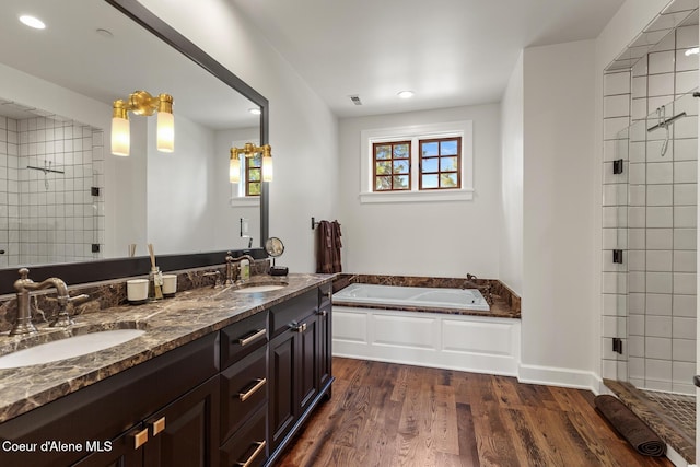 7783 S Buckrail Rd, Harrison, ID 83833 - bathroom featuring a shower stall, double vanity, a bath, wood finished floors, and recessed lighting