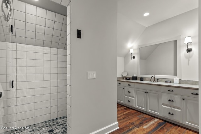 7783 S Buckrail Rd, Harrison, ID 83833 - bathroom with a tile shower, vanity, wood finished floors, recessed lighting, and vaulted ceiling
