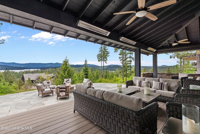 7783 S Buckrail Rd, Harrison, ID 83833 - deck with an outdoor living space, a ceiling fan, a mountain view, and a patio
