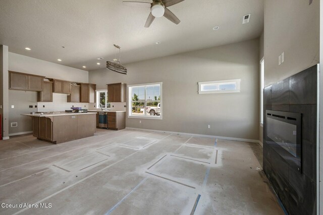 7400 N Breaux Dr, Coeur Dalene, ID 83815 - kitchen featuring a center island, a ceiling fan, stainless steel dishwasher, baseboards, and light countertops