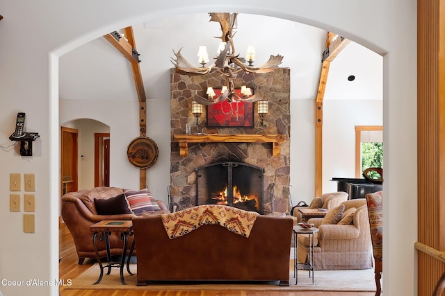 2672 Merril Martin Rd, Sagle, ID 83860 - living area with arched walkways, a fireplace, a chandelier, and wood finished floors