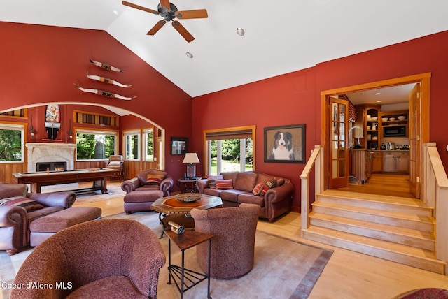 2672 Merril Martin Rd, Sagle, ID 83860 - living room featuring wood finished floors, ceiling fan, stairs, a premium fireplace, and high vaulted ceiling