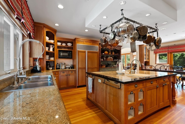 2672 Merril Martin Rd, Sagle, ID 83860 - kitchen with built in appliances, open shelves, an island with sink, recessed lighting, and light wood finished floors