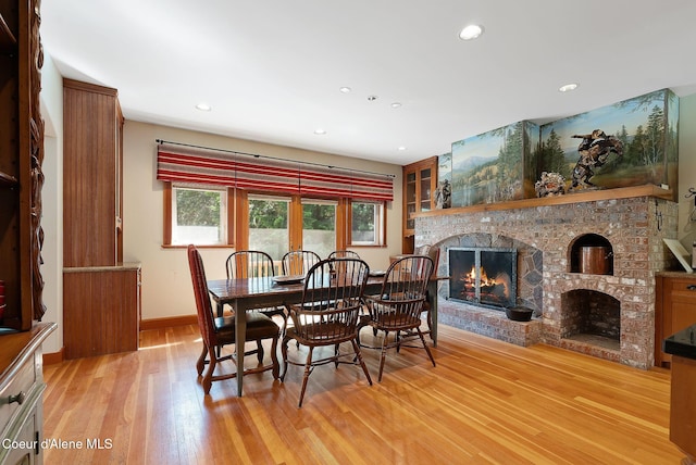2672 Merril Martin Rd, Sagle, ID 83860 - dining area featuring a lit fireplace, light wood-style flooring, and recessed lighting