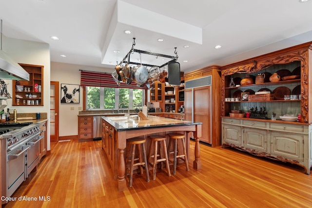 2672 Merril Martin Rd, Sagle, ID 83860 - kitchen with open shelves, high end appliances, light wood finished floors, recessed lighting, and a breakfast bar area