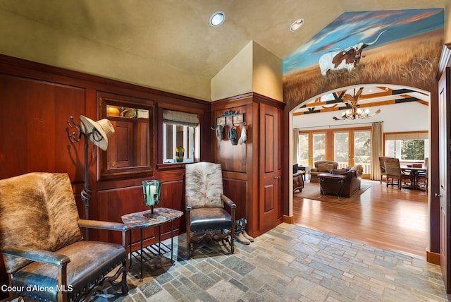 2672 Merril Martin Rd, Sagle, ID 83860 - living area featuring arched walkways, a chandelier, recessed lighting, high vaulted ceiling, and stone tile flooring