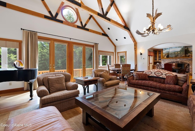 2672 Merril Martin Rd, Sagle, ID 83860 - living area featuring french doors, high vaulted ceiling, a chandelier, arched walkways, and beamed ceiling