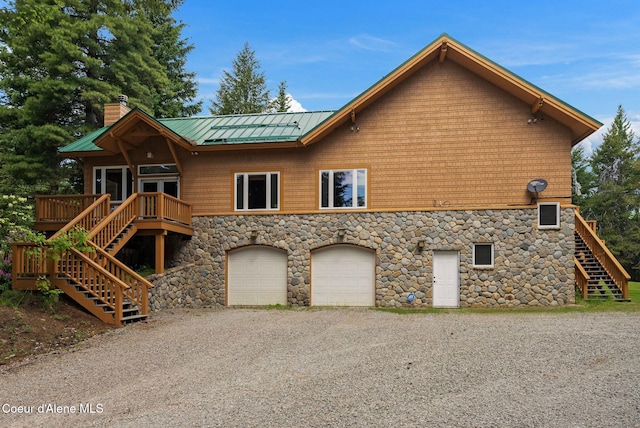 2672 Merril Martin Rd, Sagle, ID 83860 - view of front of house featuring stairway, stone siding, a chimney, a garage, and a deck