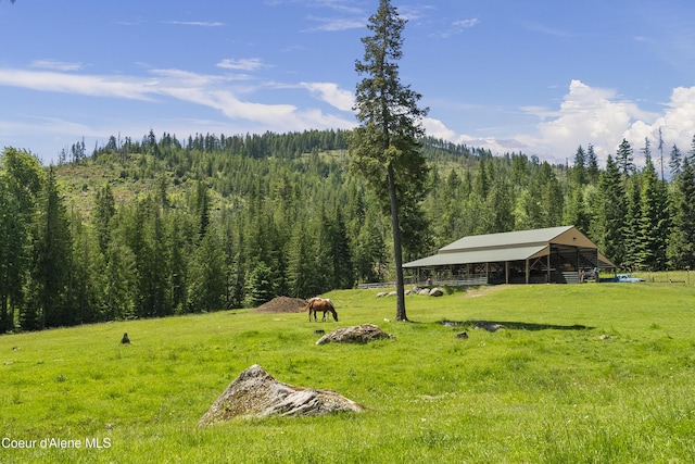 2672 Merril Martin Rd, Sagle, ID 83860 - view of yard featuring a forest view, an outbuilding, a view of rural / pastoral area, an exterior structure, and a pole building