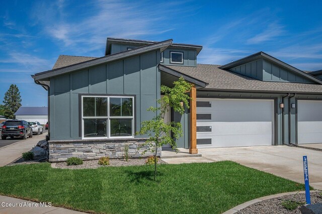 7388 N Breaux Dr, Coeur Dalene, ID 83815 - contemporary house featuring board and batten siding, roof with shingles, an attached garage, and driveway