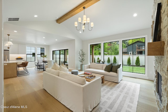 11947 N Rocking R Rd, Hayden, ID 83835 - living room featuring a stone fireplace, light wood-type flooring, recessed lighting, and a chandelier