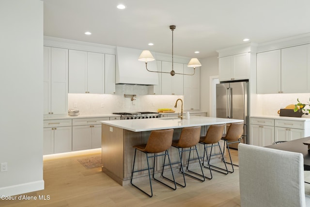 11947 N Rocking R Rd, Hayden, ID 83835 - kitchen with high end fridge, custom exhaust hood, a sink, backsplash, and recessed lighting