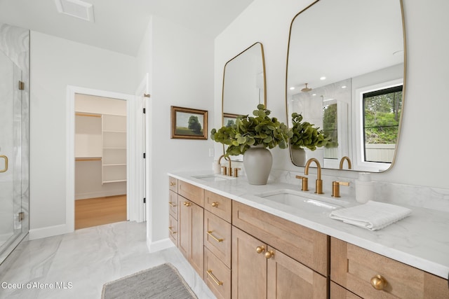 11947 N Rocking R Rd, Hayden, ID 83835 - full bathroom featuring a stall shower, double vanity, marble finish floors, and a walk in closet