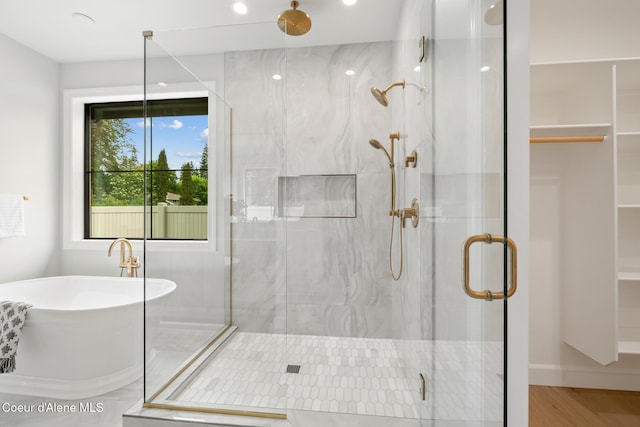11947 N Rocking R Rd, Hayden, ID 83835 - full bath with a stall shower, a freestanding tub, recessed lighting, and wood finished floors