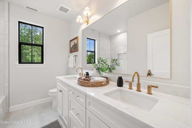 11947 N Rocking R Rd, Hayden, ID 83835 - full bathroom with healthy amount of natural light, double vanity, toilet, and baseboards