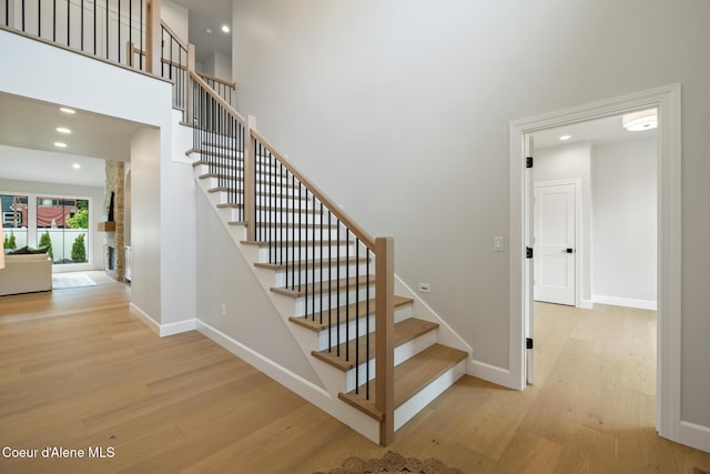 11947 N Rocking R Rd, Hayden, ID 83835 - staircase featuring wood finished floors, baseboards, recessed lighting, and a high ceiling