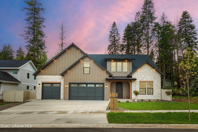 11947 N Rocking R Rd, Hayden, ID 83835 - view of front of home with stone siding, driveway, board and batten siding, a garage, and a standing seam roof