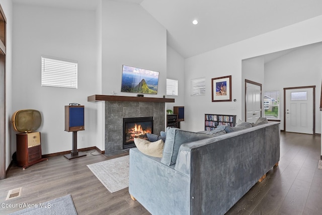 4463 E Marble Fox Ave, Post Falls, ID 83854 - living area with high vaulted ceiling, a tile fireplace, wood finished floors, recessed lighting, and baseboards