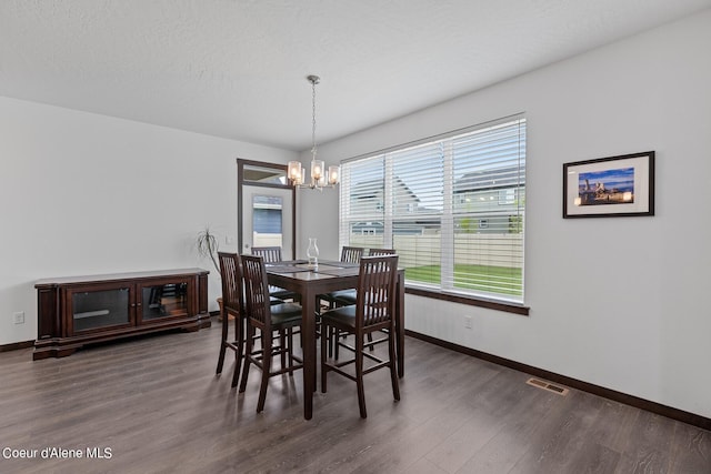 4463 E Marble Fox Ave, Post Falls, ID 83854 - dining space featuring a chandelier, baseboards, and wood finished floors