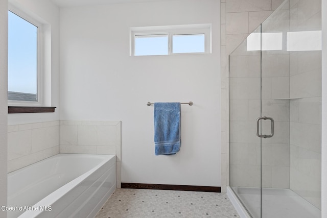 4463 E Marble Fox Ave, Post Falls, ID 83854 - bathroom featuring a stall shower, a bath, and baseboards
