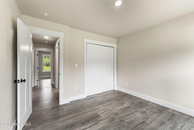 193 Grouse Rd, Sandpoint, ID 83864 - unfurnished bedroom with dark wood-type flooring, baseboards, a closet, and recessed lighting
