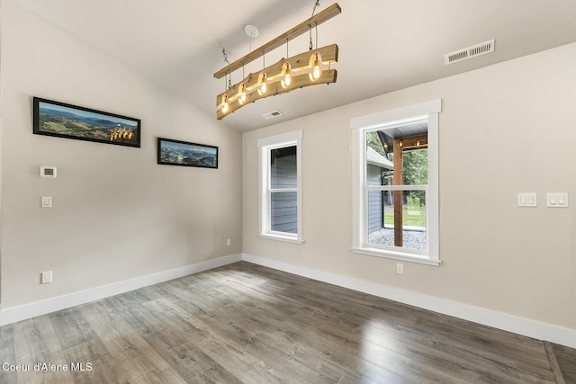 193 Grouse Rd, Sandpoint, ID 83864 - spare room featuring vaulted ceiling, baseboards, and wood finished floors