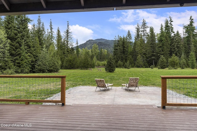 193 Grouse Rd, Sandpoint, ID 83864 - deck with a mountain view, a lawn, a forest view, and a patio area