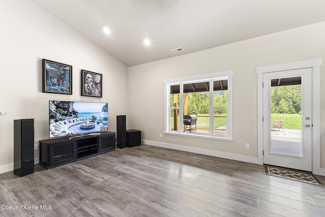 193 Grouse Rd, Sandpoint, ID 83864 - unfurnished living room featuring wood finished floors, lofted ceiling, baseboards, and recessed lighting