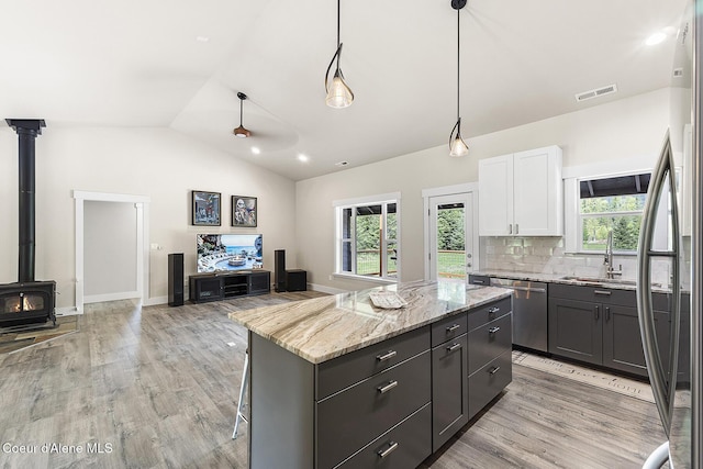 193 Grouse Rd, Sandpoint, ID 83864 - kitchen featuring a sink, appliances with stainless steel finishes, lofted ceiling, a kitchen island, and healthy amount of natural light