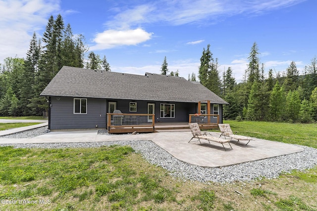 193 Grouse Rd, Sandpoint, ID 83864 - back of house featuring a patio area, a lawn, and roof with shingles