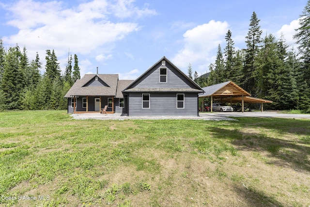 193 Grouse Rd, Sandpoint, ID 83864 - back of house with a porch, a yard, a carport, and driveway