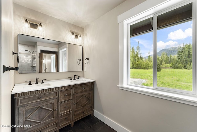 193 Grouse Rd, Sandpoint, ID 83864 - bathroom with baseboards, double vanity, and tiled shower