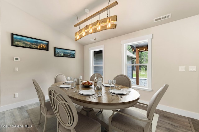 193 Grouse Rd, Sandpoint, ID 83864 - dining room featuring wood finished floors, baseboards, and lofted ceiling