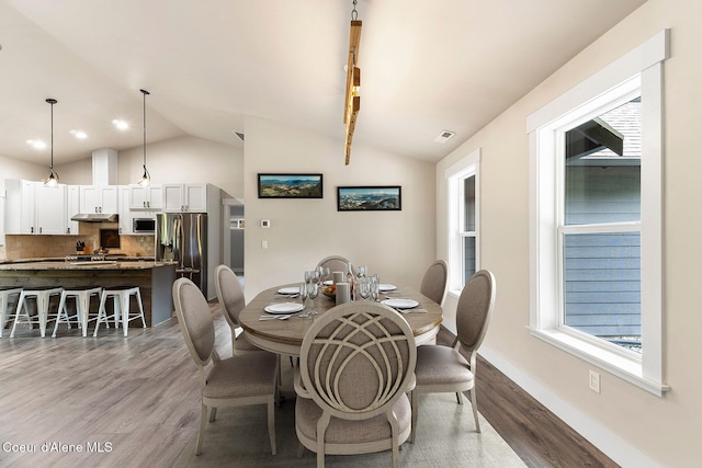 193 Grouse Rd, Sandpoint, ID 83864 - dining area with vaulted ceiling, wood finished floors, and baseboards