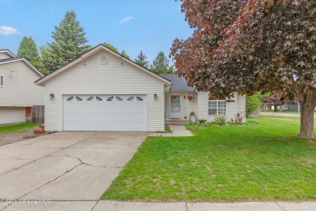 821 W Mustang Ave, Hayden, ID 83835 - view of front facade with driveway, a front yard, and an attached garage