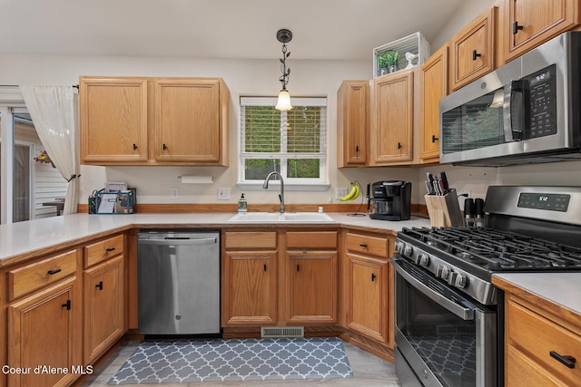 821 W Mustang Ave, Hayden, ID 83835 - kitchen with appliances with stainless steel finishes, a sink, light countertops, and pendant lighting