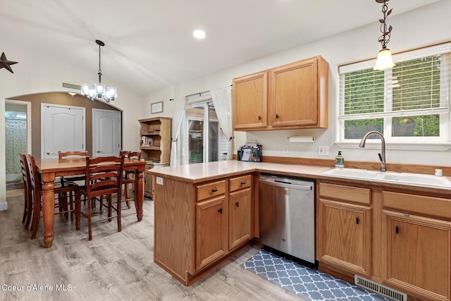 821 W Mustang Ave, Hayden, ID 83835 - kitchen featuring stainless steel dishwasher, a sink, light wood finished floors, a peninsula, and a chandelier