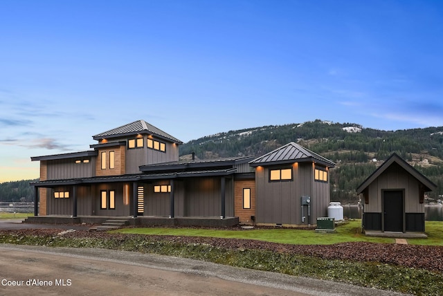 1808 Garfield Bay Rd, Sagle, ID 83860 - view of front of home with a standing seam roof, metal roof, board and batten siding, covered porch, and a mountain view