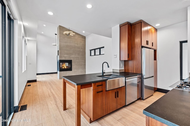 1808 Garfield Bay Rd, Sagle, ID 83860 - kitchen with stainless steel appliances, a sink, light wood finished floors, a peninsula, and recessed lighting