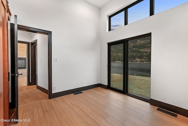 1808 Garfield Bay Rd, Sagle, ID 83860 - spare room with light wood-type flooring, baseboards, and a high ceiling