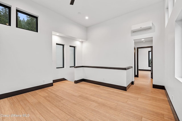 1808 Garfield Bay Rd, Sagle, ID 83860 - spare room featuring a wall mounted air conditioner, wood finished floors, a ceiling fan, baseboards, and recessed lighting