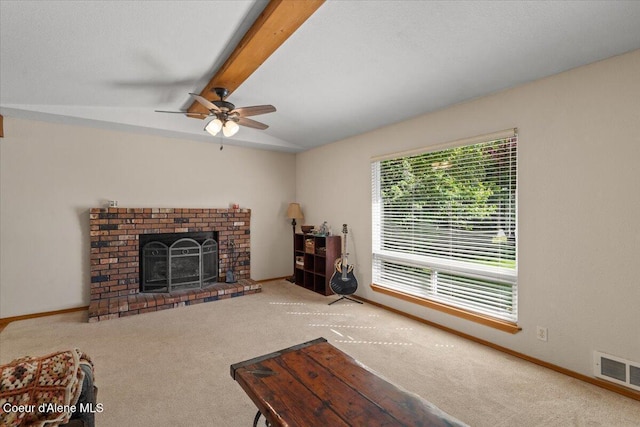 2101 W Bordeaux Ave, Hayden, ID 83835 - living room featuring carpet, a ceiling fan, beam ceiling, a brick fireplace, and baseboards