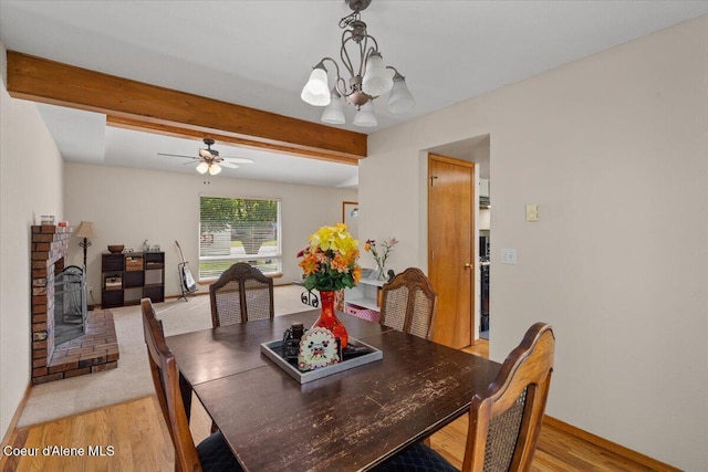 2101 W Bordeaux Ave, Hayden, ID 83835 - dining area featuring light wood finished floors, a chandelier, beamed ceiling, a ceiling fan, and baseboards