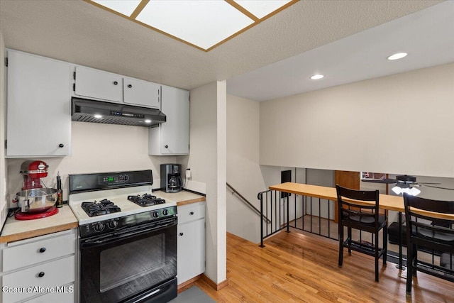 2101 W Bordeaux Ave, Hayden, ID 83835 - kitchen with gas range, under cabinet range hood, light wood finished floors, light countertops, and recessed lighting