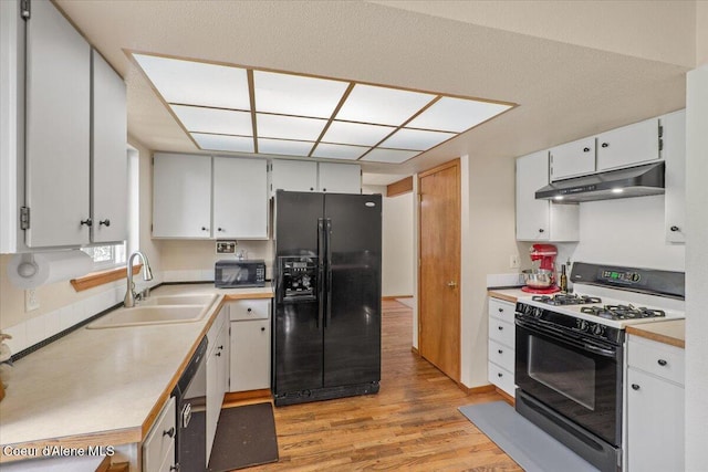 2101 W Bordeaux Ave, Hayden, ID 83835 - kitchen featuring black appliances, under cabinet range hood, a sink, light wood finished floors, and light countertops