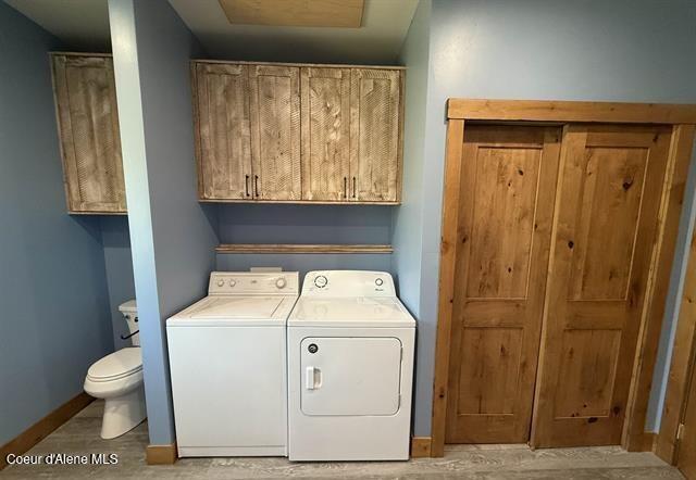 240 Canyon Dr, Kooskia, ID 83539 - laundry area with washer and dryer, wood finished floors, and baseboards