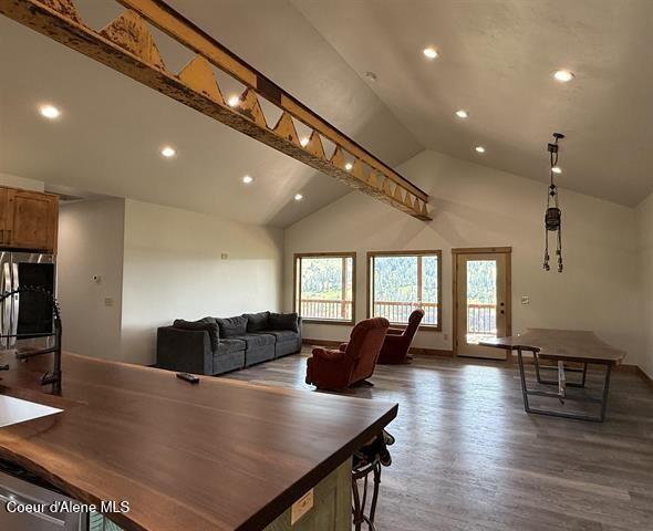 240 Canyon Dr, Kooskia, ID 83539 - dining area featuring recessed lighting, wood finished floors, high vaulted ceiling, and baseboards