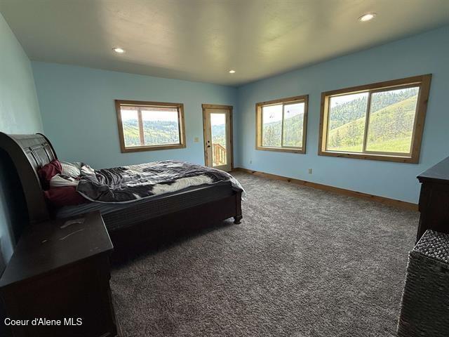 240 Canyon Dr, Kooskia, ID 83539 - bedroom featuring access to outside, multiple windows, carpet floors, recessed lighting, and baseboards
