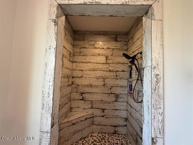 240 Canyon Dr, Kooskia, ID 83539 - bathroom featuring tiled shower and wood walls
